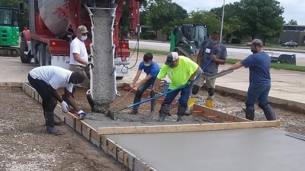 students spreading cement