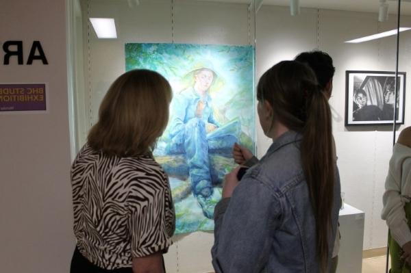 2 people with backs to camera looking at painting in ArtSpace Gallery